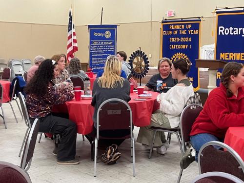 Students eatting Pizza with Rotarian Dawn Woodard.jpg