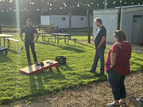 Corn hole with Arron Mabon, Jason Grantham, and Melissa Trujillo.jpg