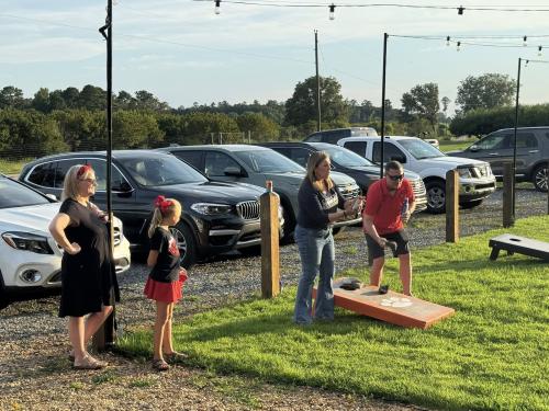 Kay Williamson and Bart Fuller trying to win at corn hole.jpg